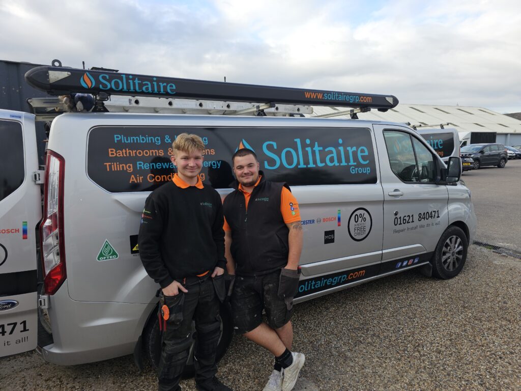 New apprentice Bobby with mentor, Spencer leaning against the work van